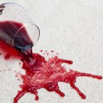 High Angle View Of Red Wine Spilled From Glass On Carpet
