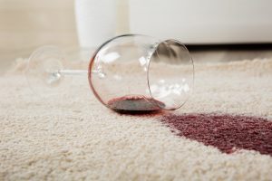 High Angle View Of Red Wine Spilled From Glass On Carpet